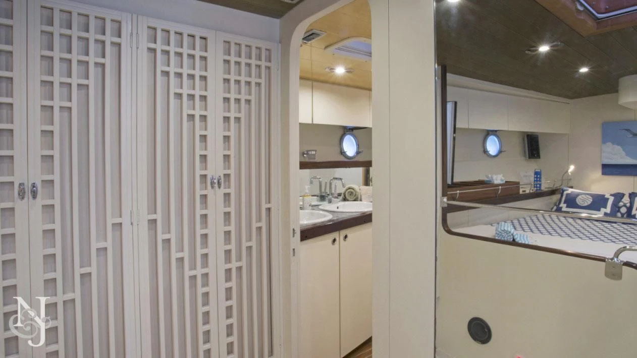 a kitchen with white cabinets aboard WISDOM Yacht for Sale