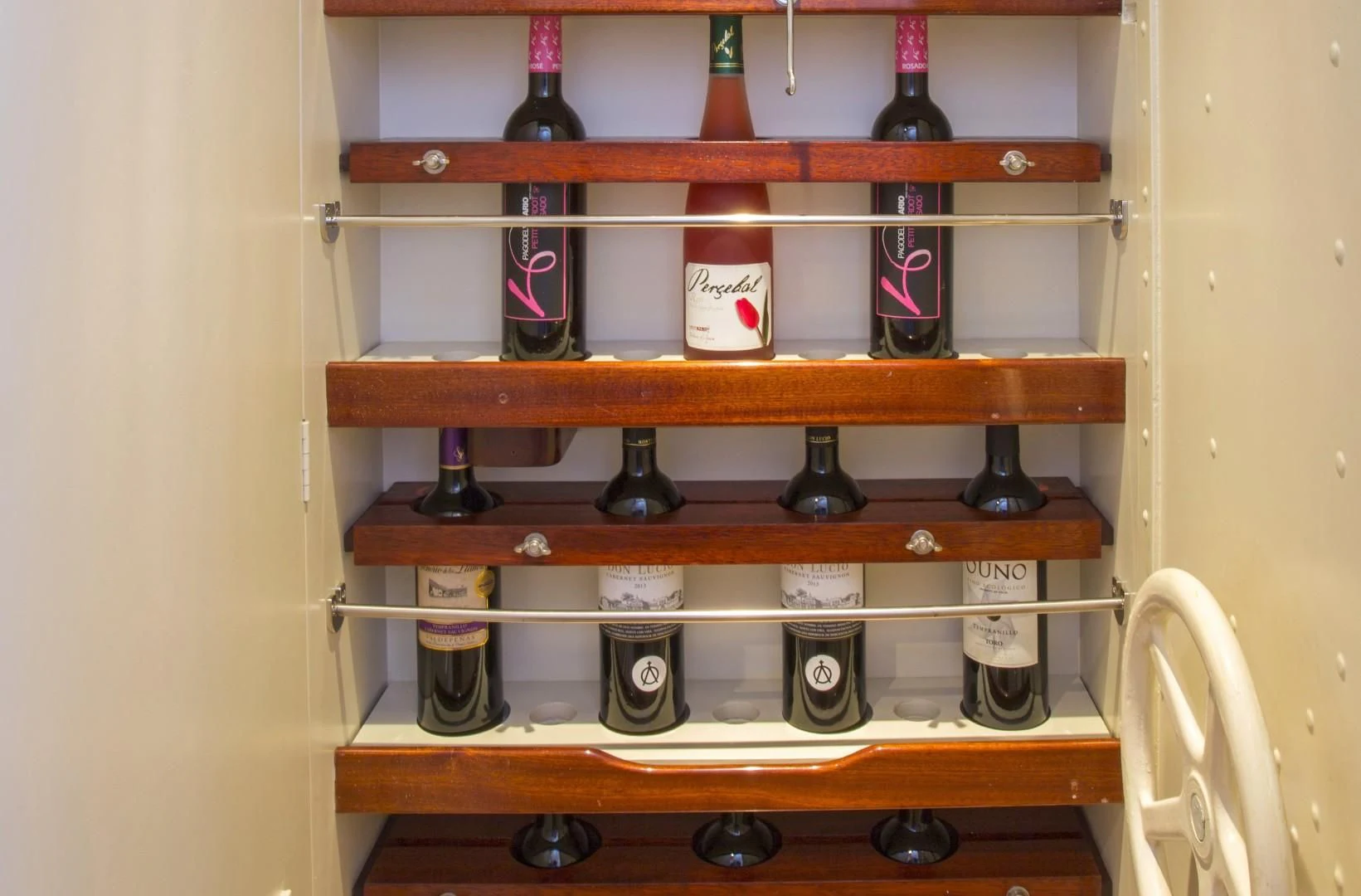 a shelf with a variety of bottles on it aboard WISDOM Yacht for Sale