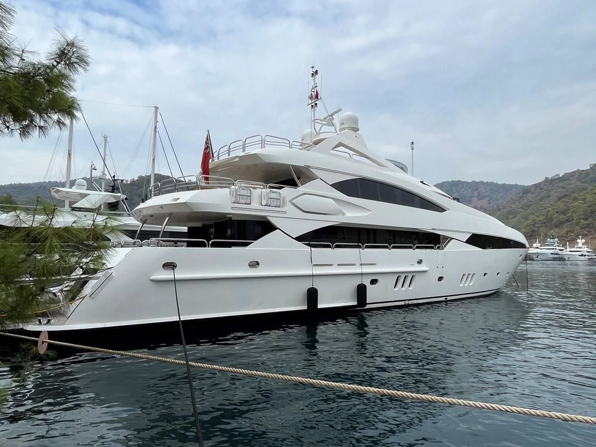 a white yacht docked aboard IMAN Yacht for Sale