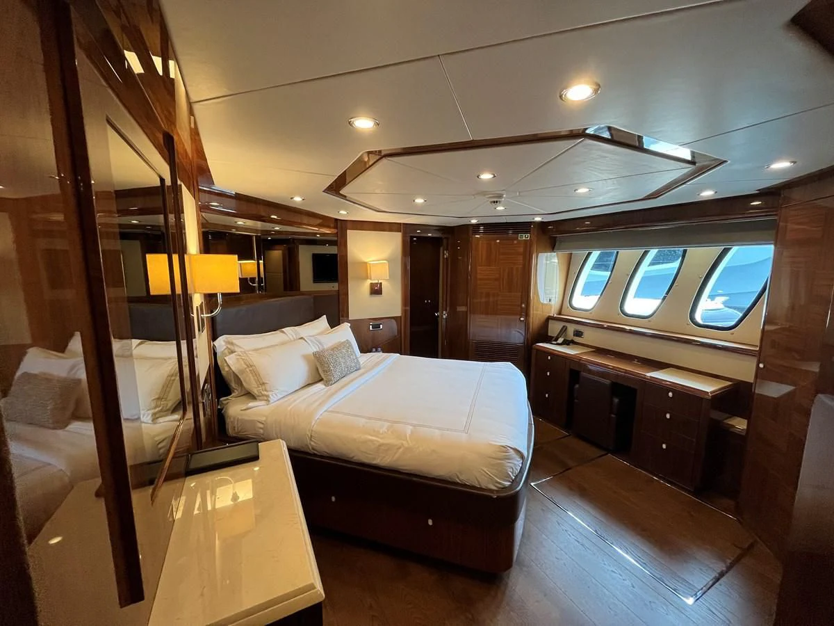 a hotel room with a bed and a desk aboard IMAN Yacht for Sale