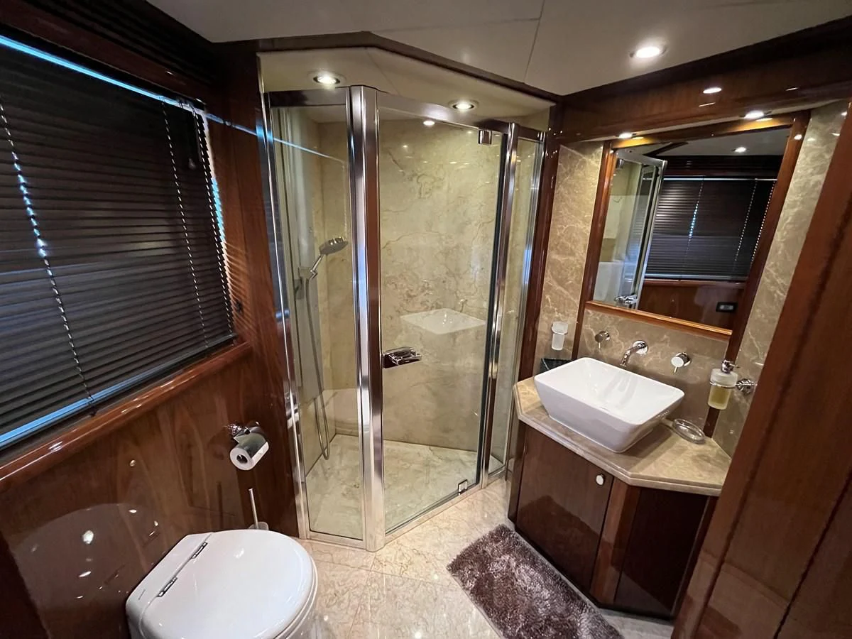 a bathroom with a glass shower aboard IMAN Yacht for Sale