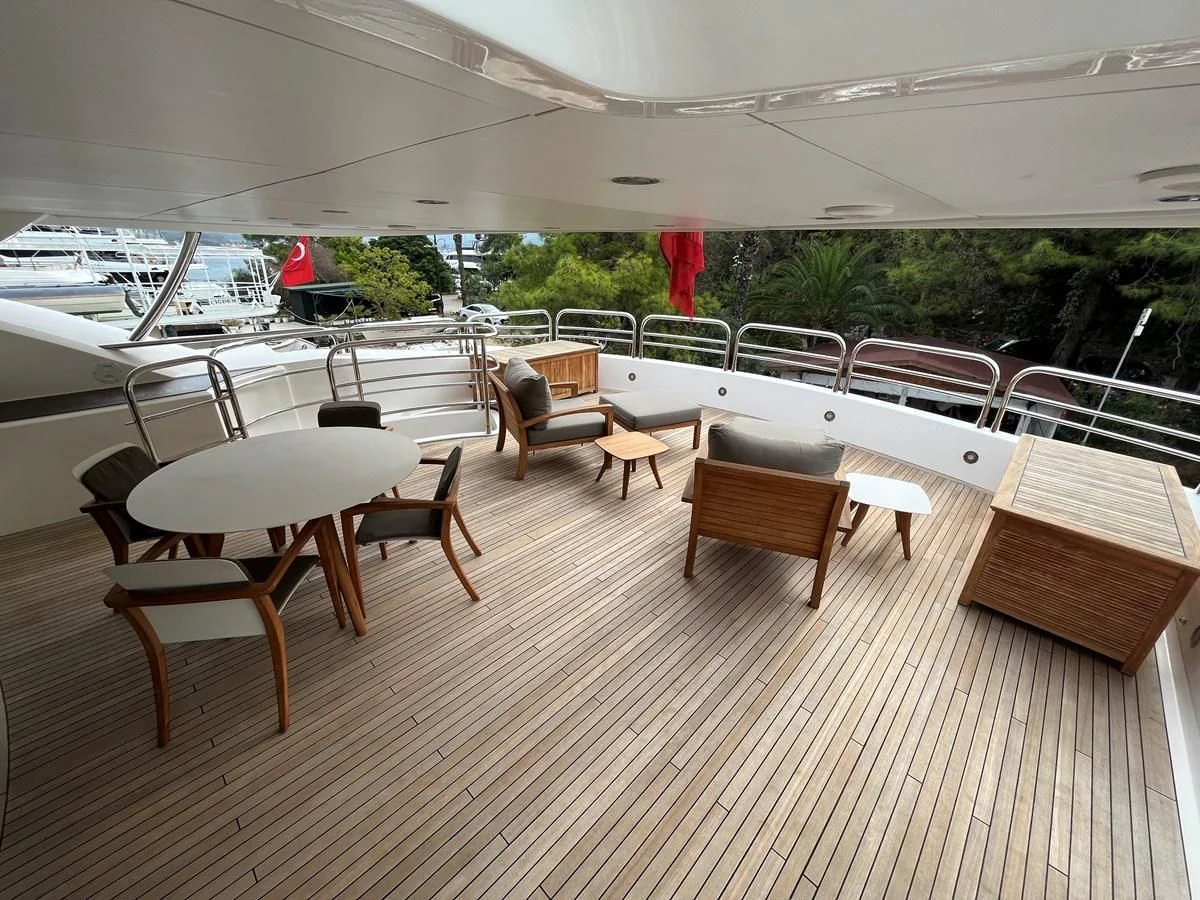 a room with many chairs and tables aboard IMAN Yacht for Sale
