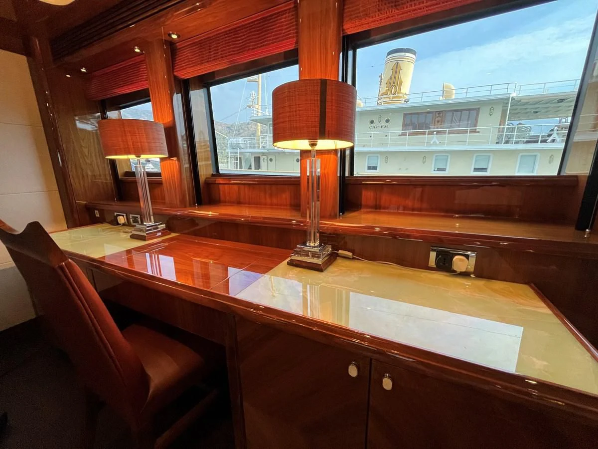 a room with a table and chairs aboard IMAN Yacht for Sale