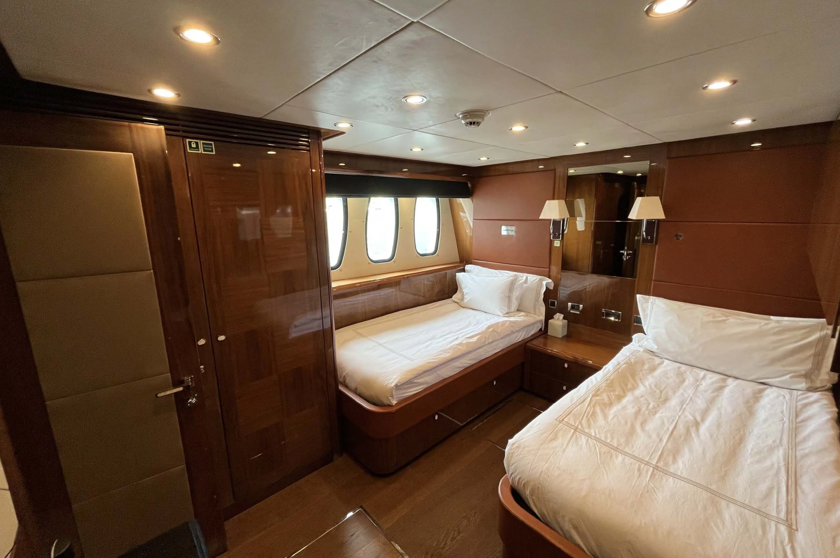 a room with a bed and a closet aboard IMAN Yacht for Sale