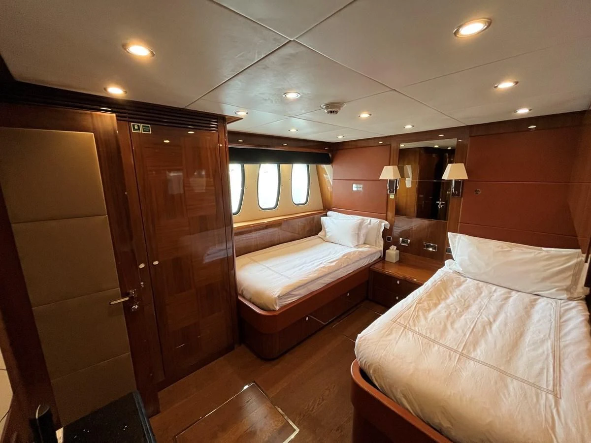 a room with a bed and a closet aboard IMAN Yacht for Sale