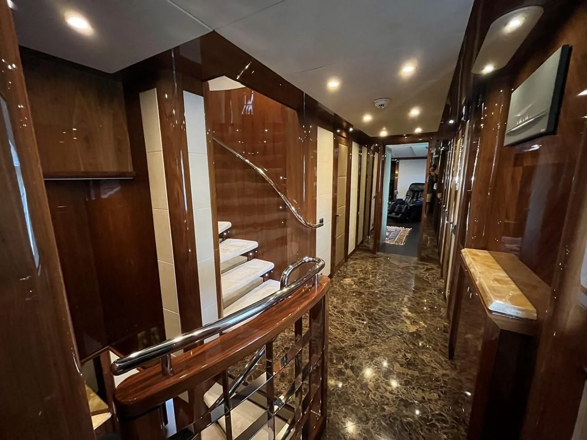 a hallway with wood walls aboard IMAN Yacht for Sale