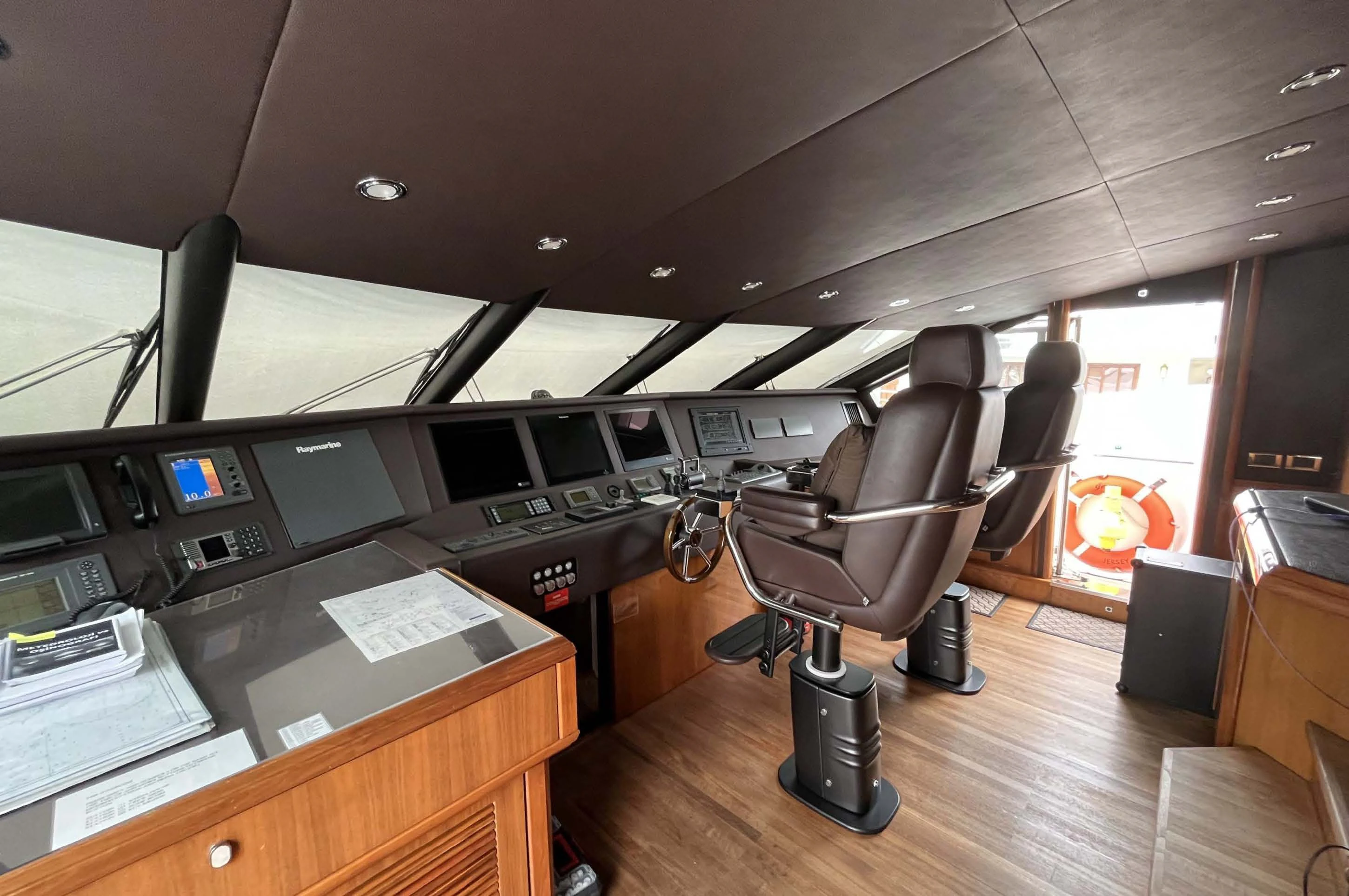 a room with a desk and chairs aboard IMAN Yacht for Sale