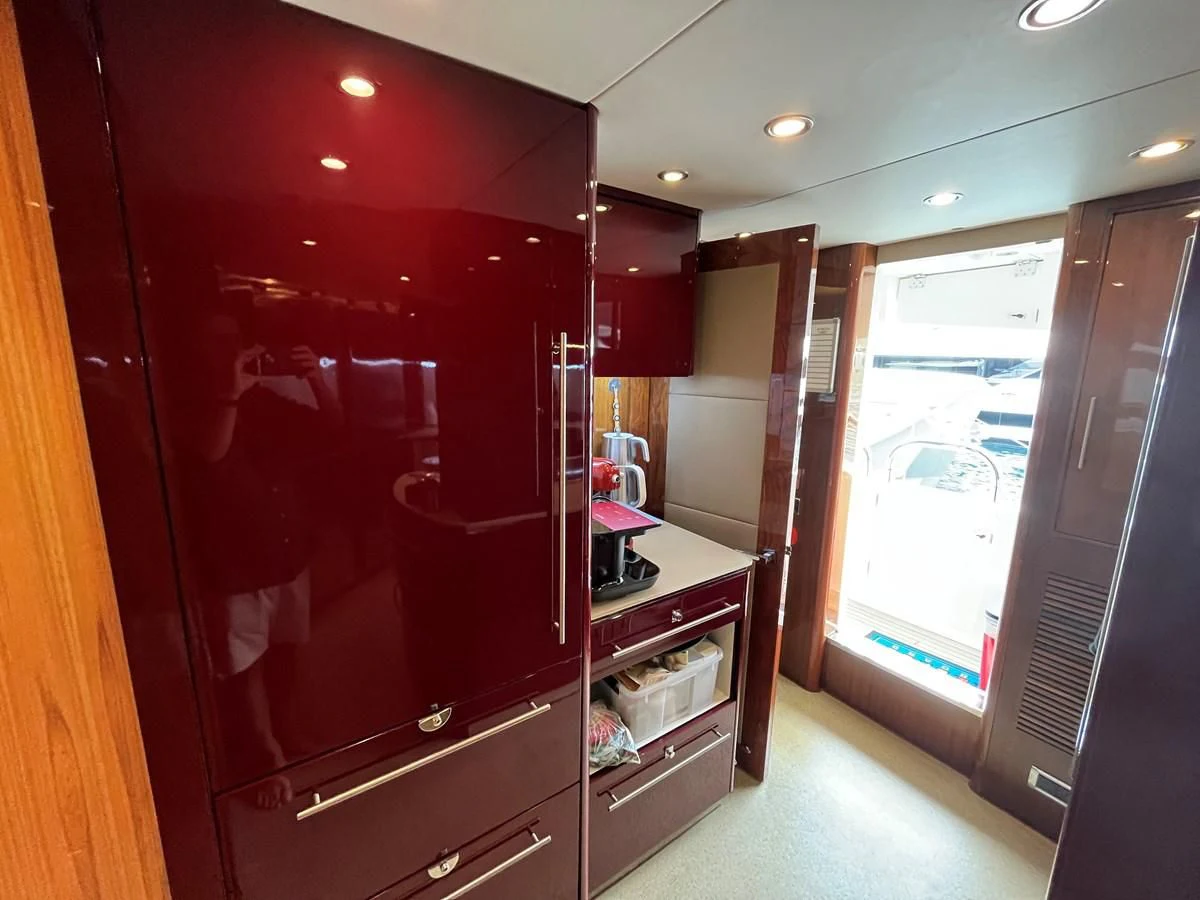 a kitchen with red cabinets aboard IMAN Yacht for Sale