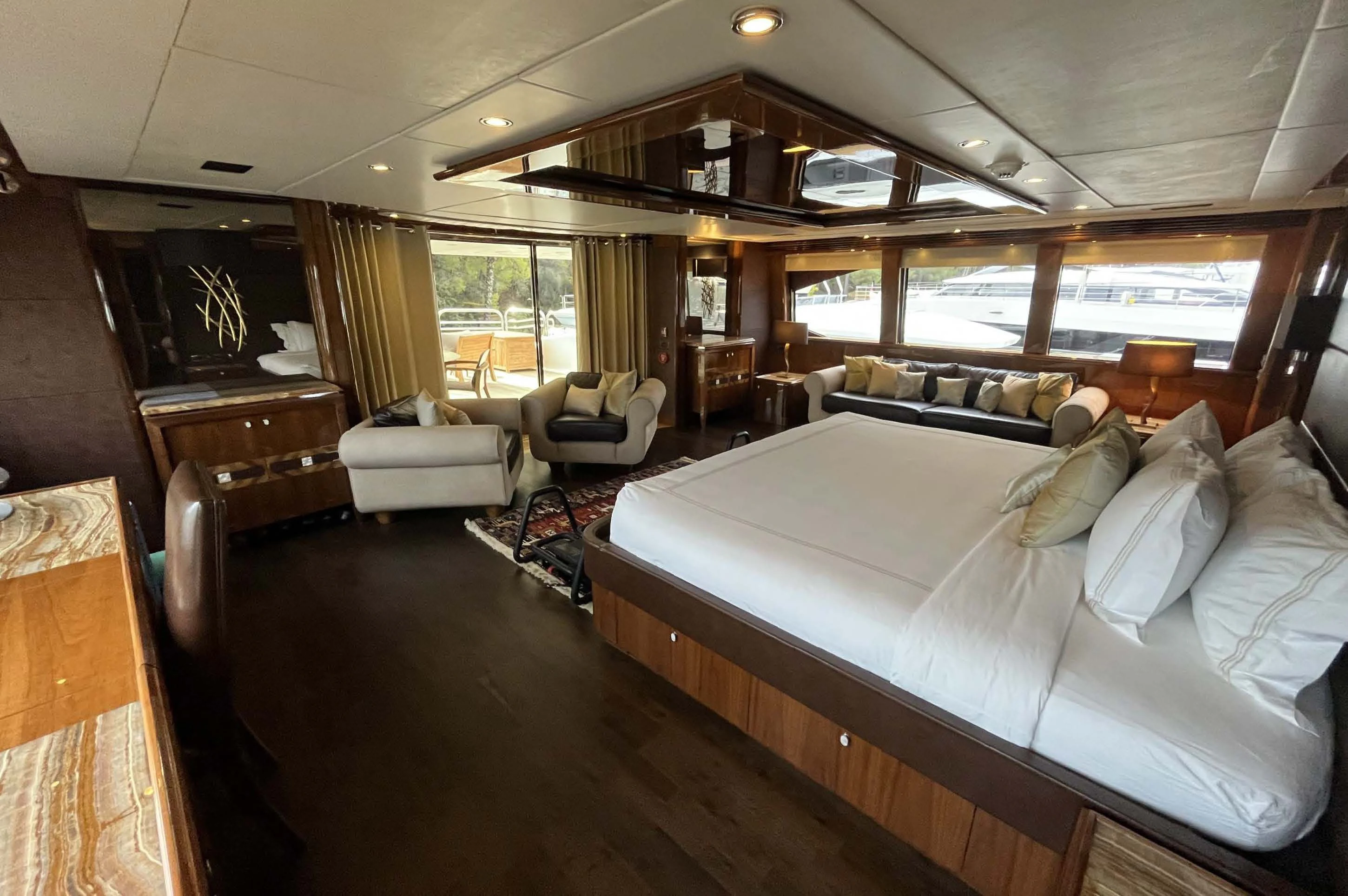 a large bedroom with a large bed aboard IMAN Yacht for Sale