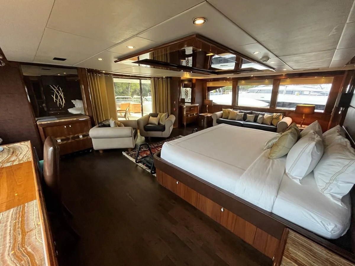 a large bedroom with a large bed aboard IMAN Yacht for Sale