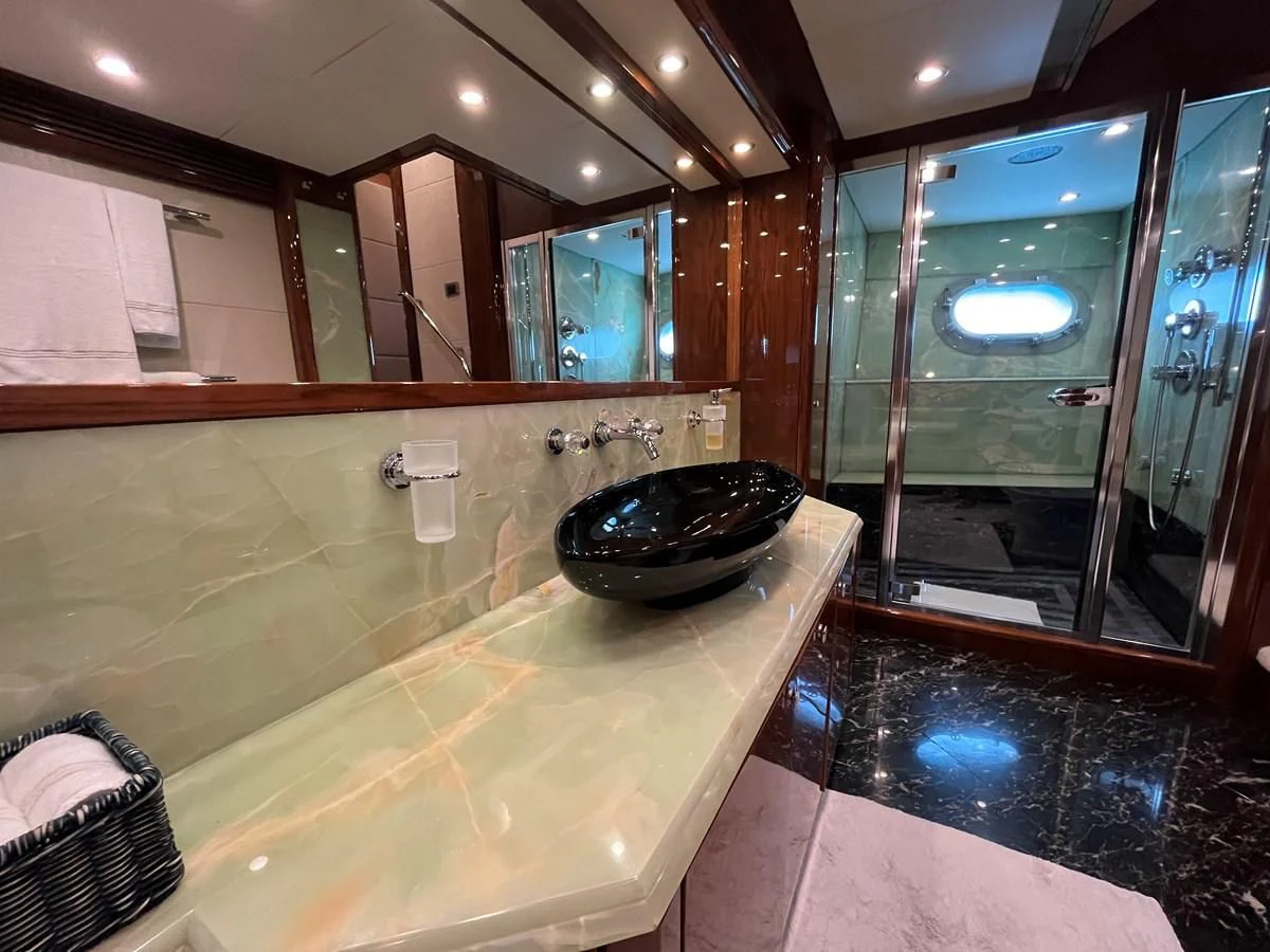 a bathroom with a large marble counter aboard IMAN Yacht for Sale