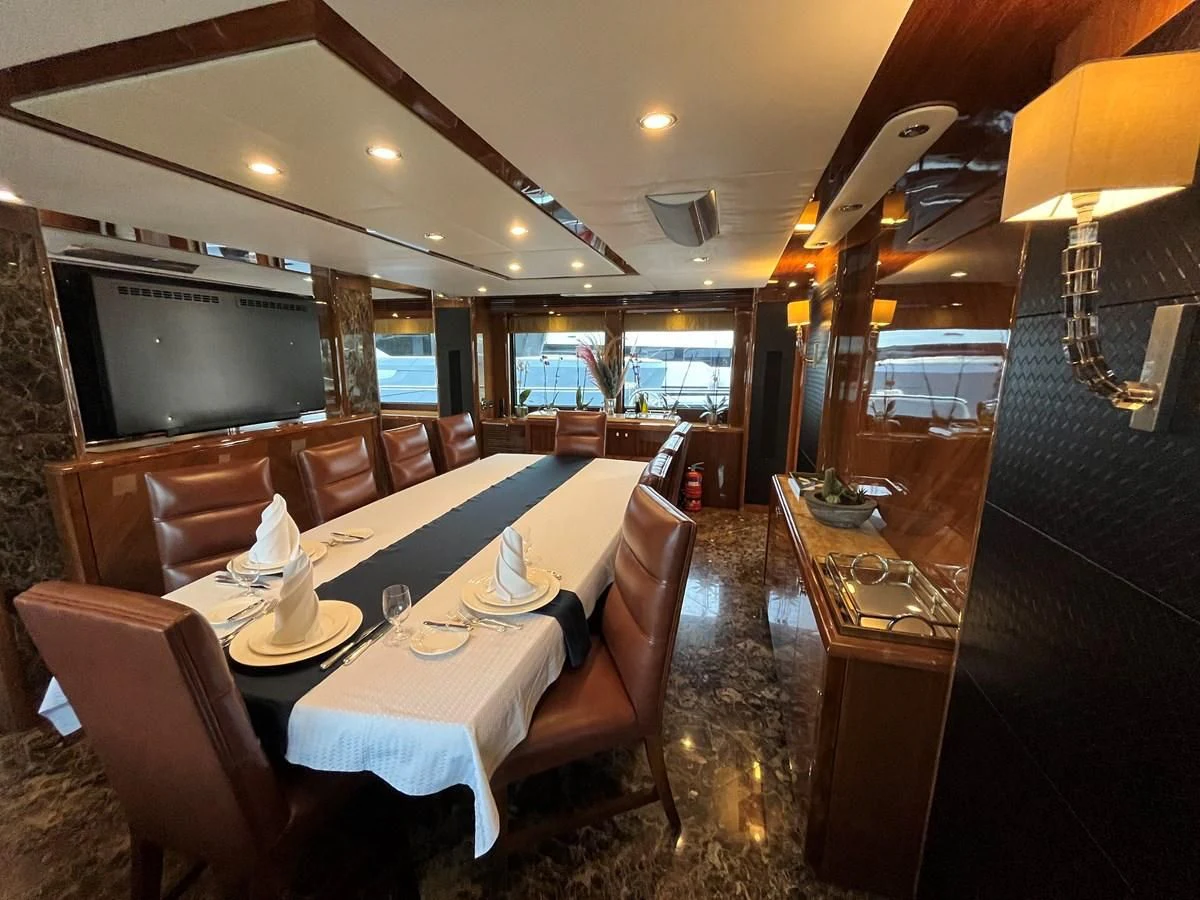 a dining room with a large table aboard IMAN Yacht for Sale