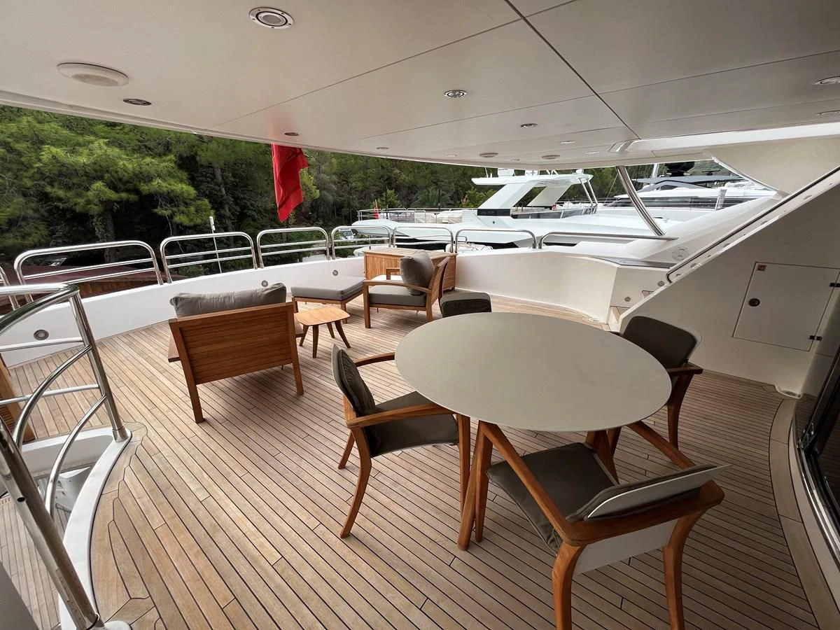 a room with chairs and tables aboard IMAN Yacht for Sale