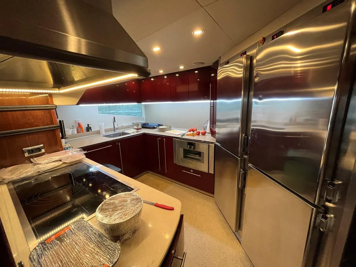 a kitchen with a stainless steel refrigerator aboard IMAN Yacht for Sale