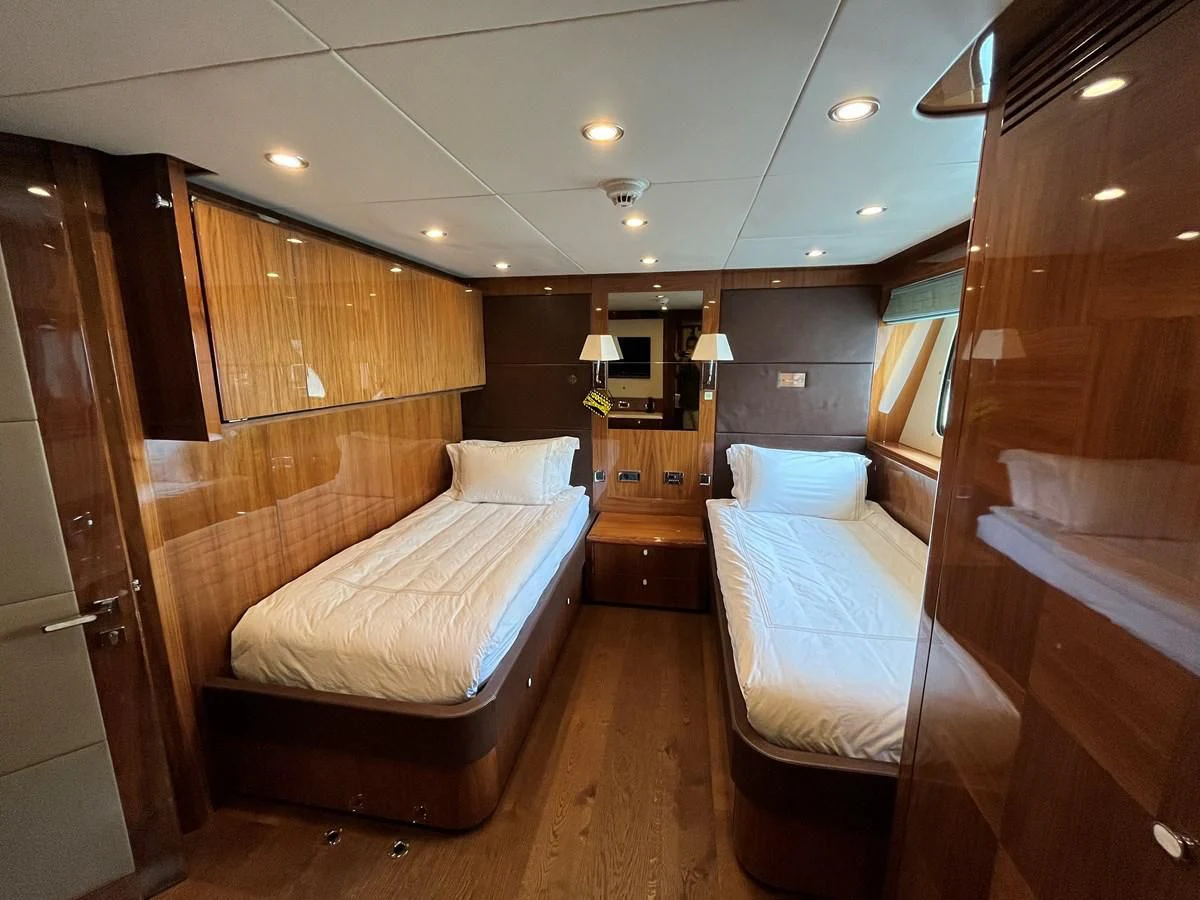 a room with a bed and a mirror aboard IMAN Yacht for Sale