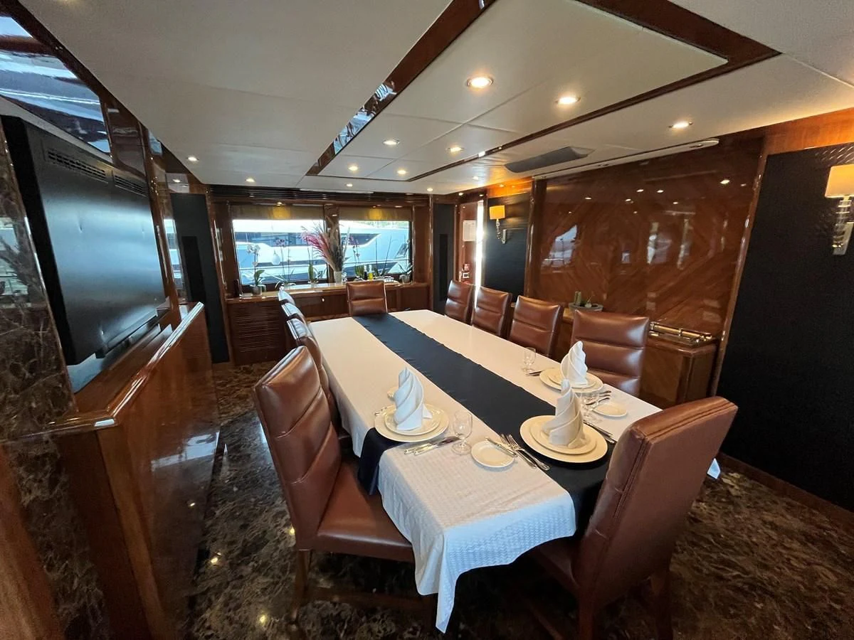 a dining room with a table and chairs aboard IMAN Yacht for Sale