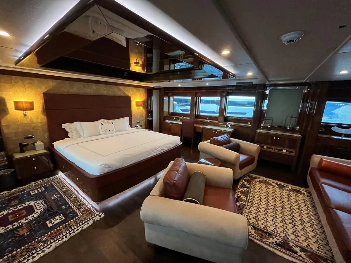 a living room with a large bed aboard IMAN Yacht for Sale