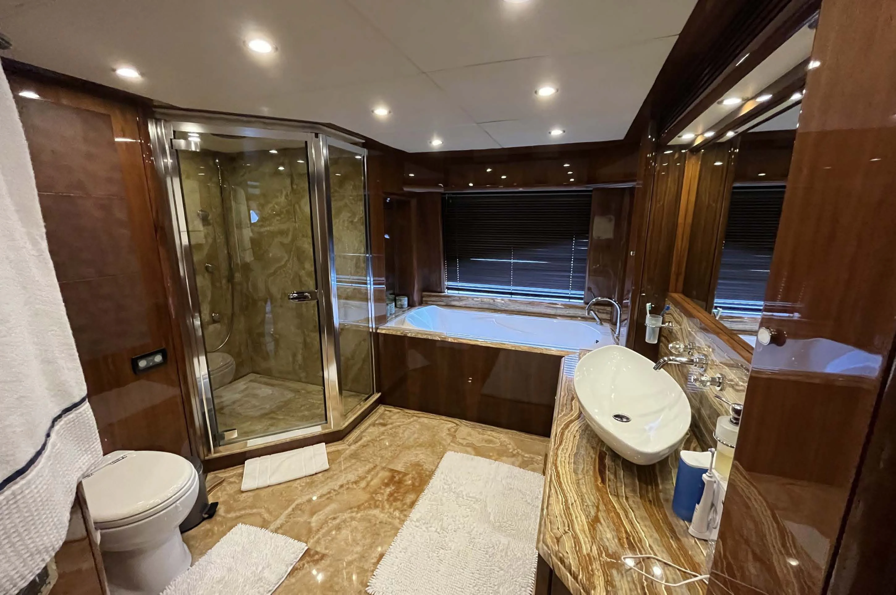 a bathroom with a tub sink and toilet aboard IMAN Yacht for Sale