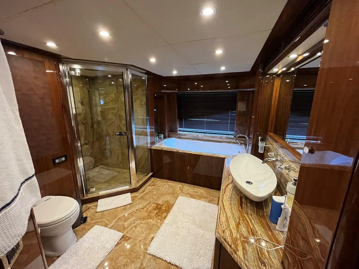 a bathroom with a glass shower aboard IMAN Yacht for Sale