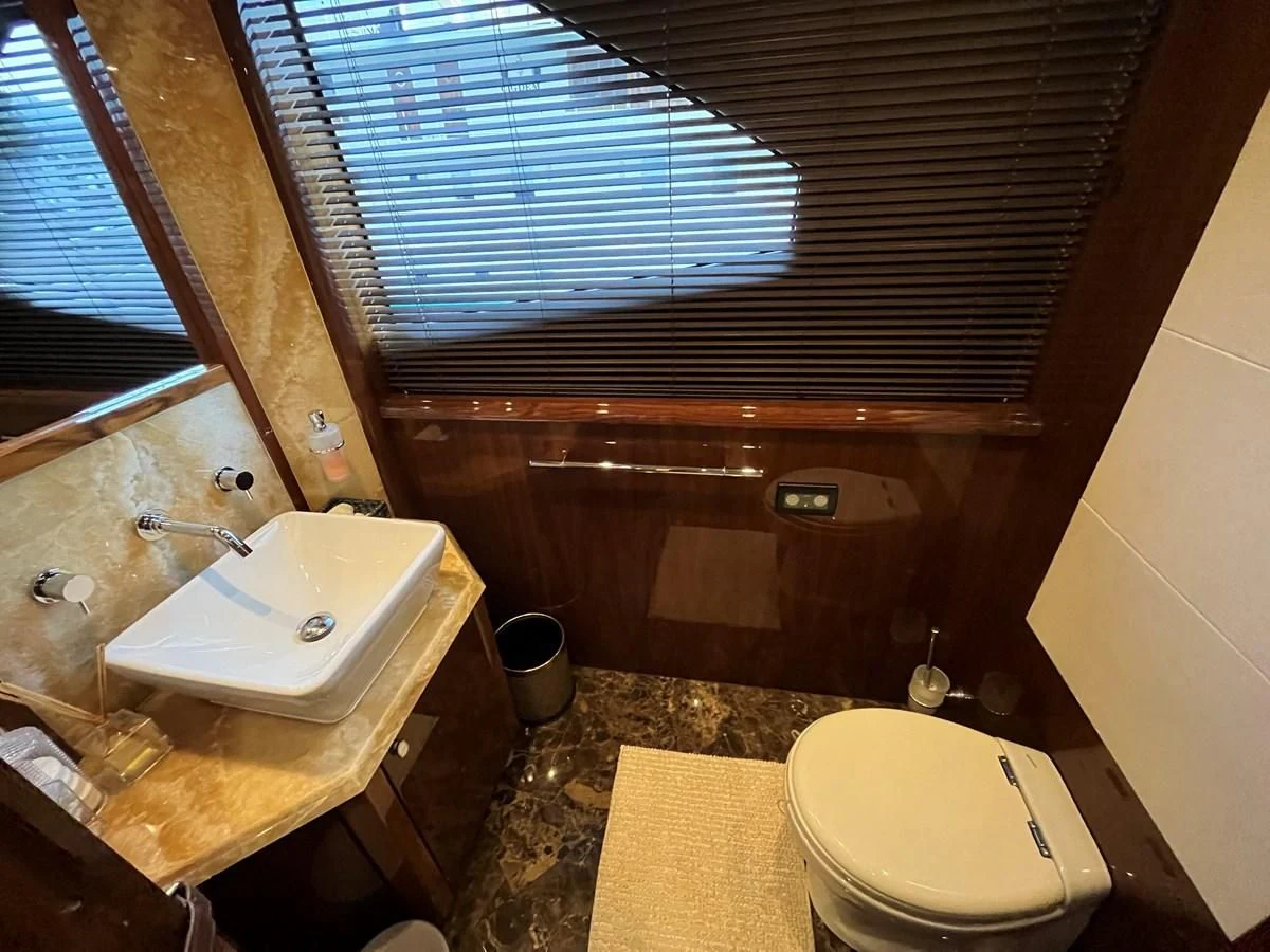 a bathroom with a toilet and a sink aboard IMAN Yacht for Sale