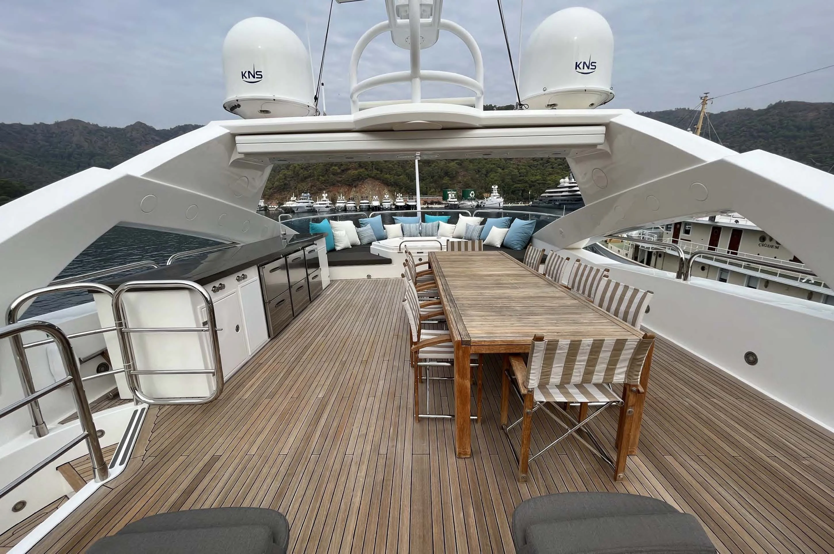 a deck with a table and chairs on it aboard IMAN Yacht for Sale
