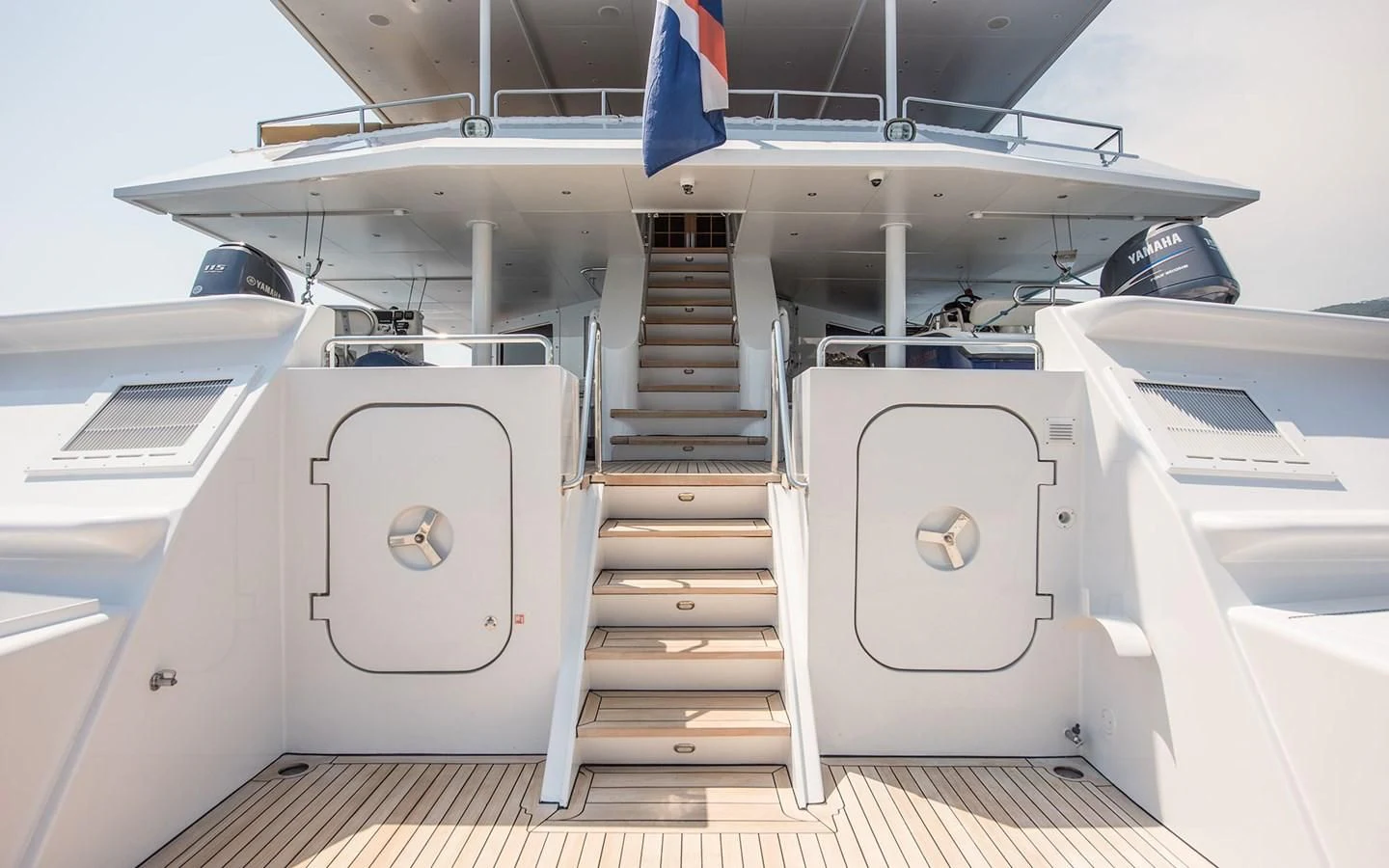a white boat with a blue stripe aboard BLUE STAR Yacht for Sale