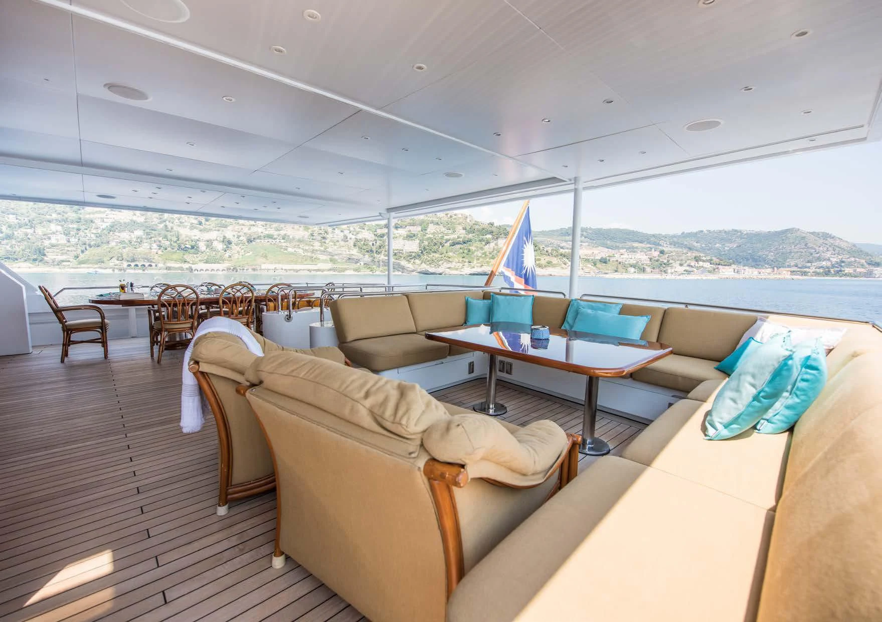 a large living room with a table and chairs aboard BLUE STAR Yacht for Sale