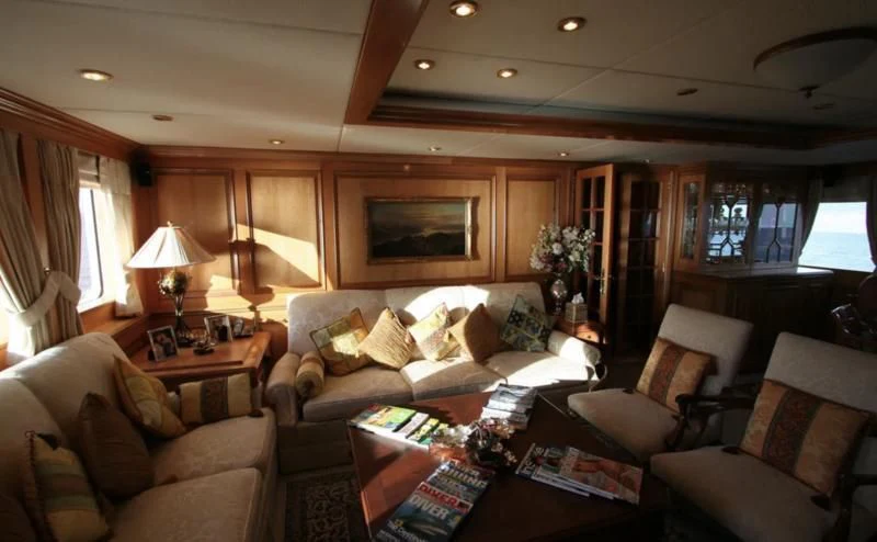 a living room with a couch and a fireplace aboard BLUE STAR Yacht for Sale