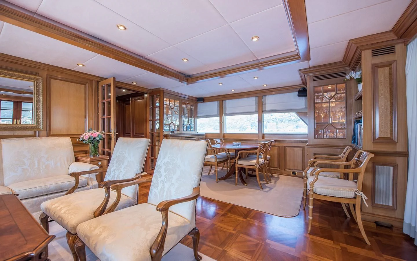 a living room with wood furniture aboard BLUE STAR Yacht for Sale
