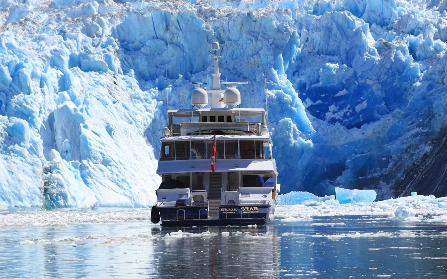 a boat on water with icebergs in the background aboard BLUE STAR Yacht for Sale