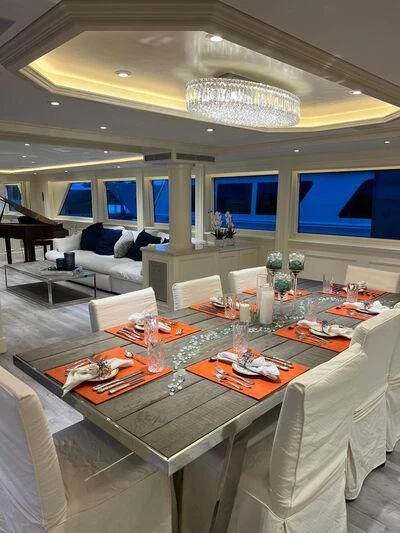 a large room with a table and chairs aboard OCEAN DRIVE Yacht for Sale