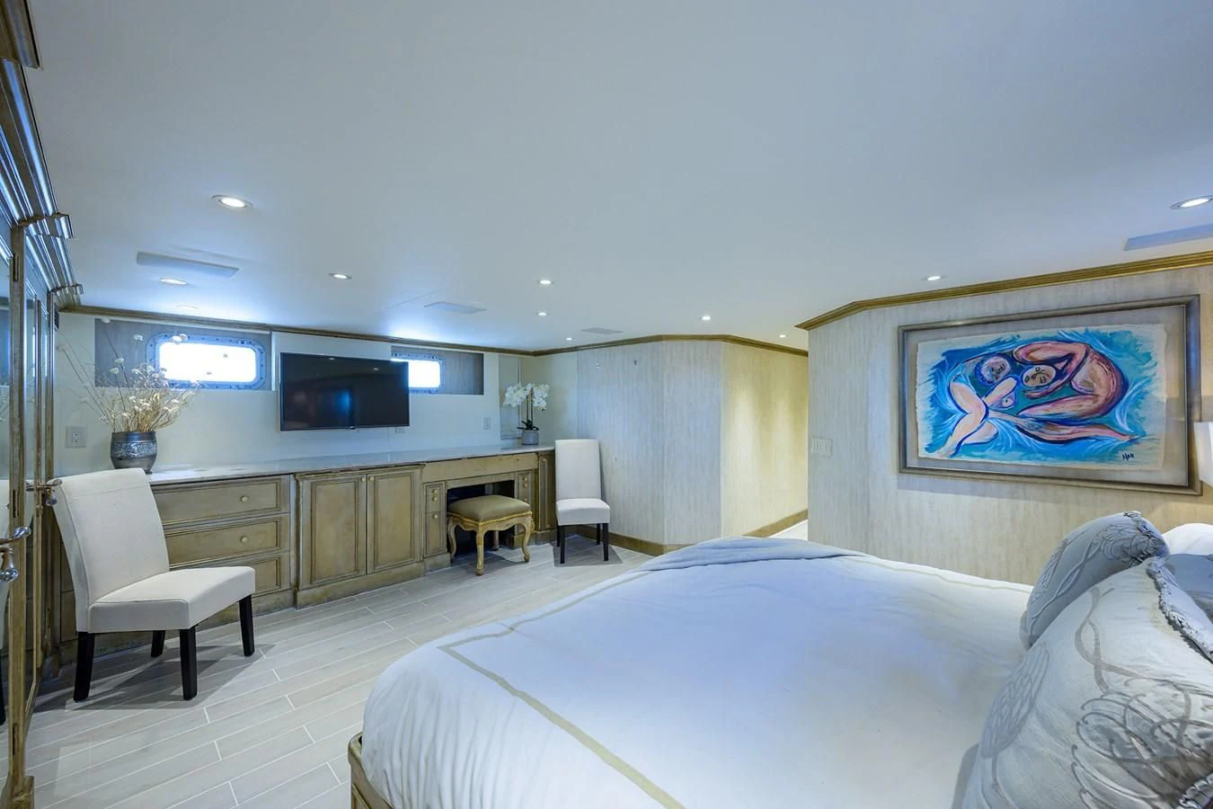 a bedroom with a bed and a tv on the wall aboard OCEAN DRIVE Yacht for Sale