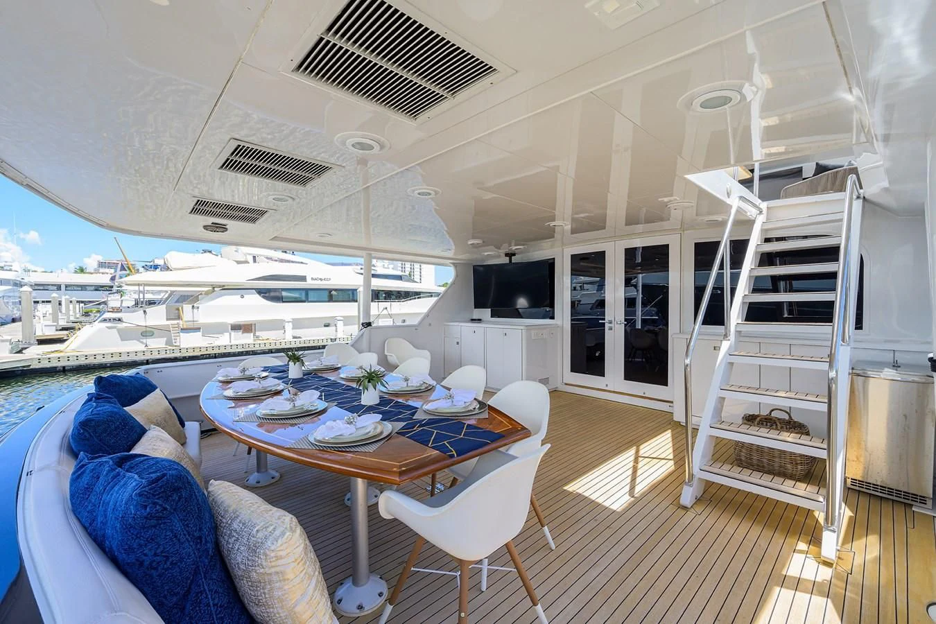 a large white tent with a table and chairs and a large white ladder aboard OCEAN DRIVE Yacht for Sale
