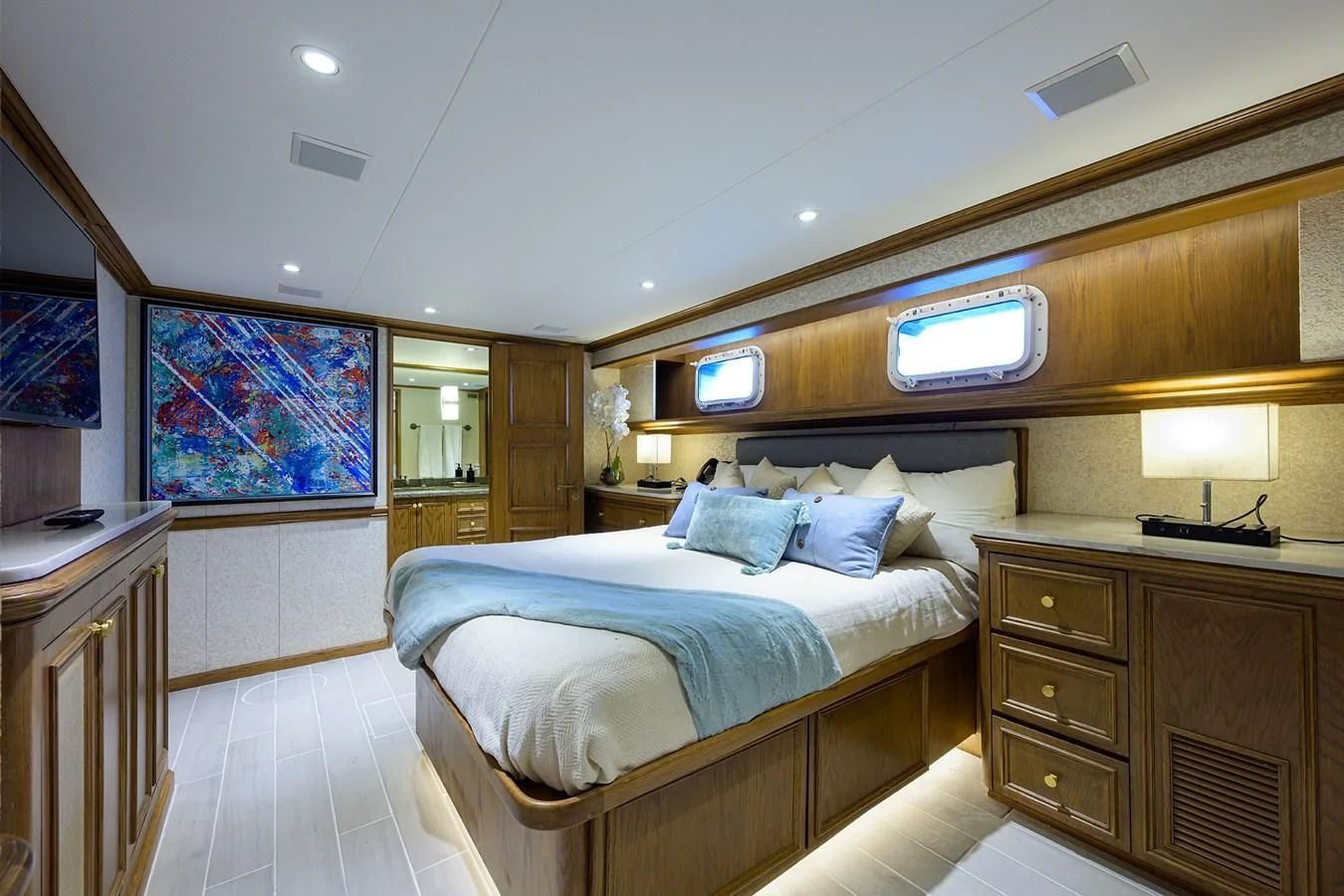 a bedroom with a bed and a dresser aboard OCEAN DRIVE Yacht for Sale
