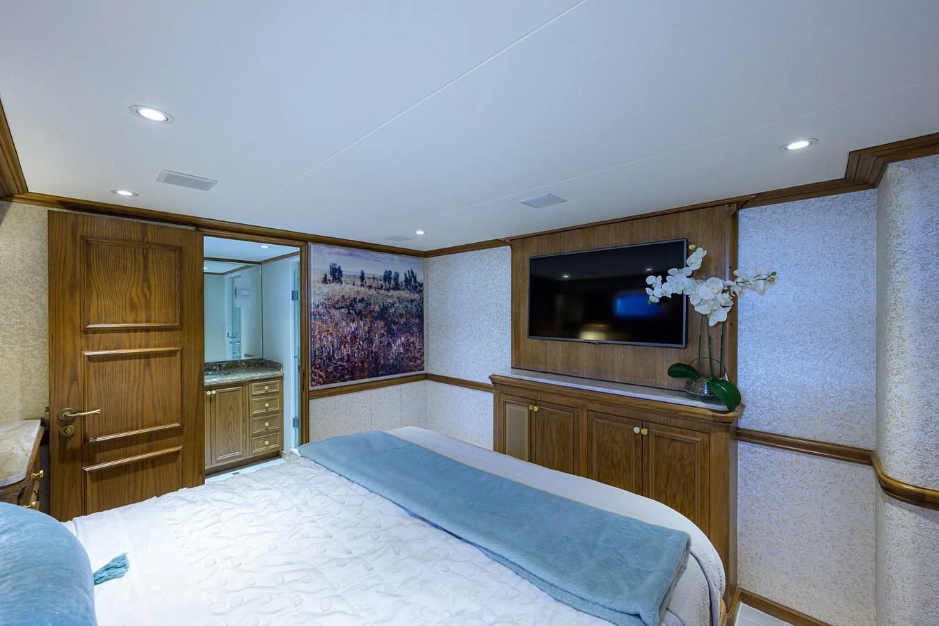 a bedroom with a bed and television aboard OCEAN DRIVE Yacht for Sale
