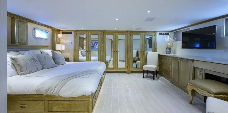 a large bedroom with a bed and a tv aboard OCEAN DRIVE Yacht for Sale