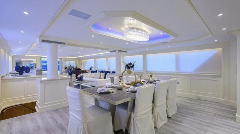 a room with tables and chairs aboard OCEAN DRIVE Yacht for Sale
