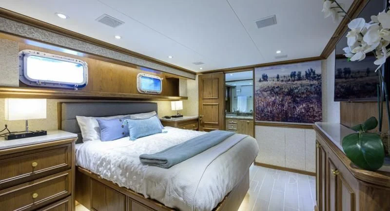 a bedroom with a bed and a television aboard OCEAN DRIVE Yacht for Sale