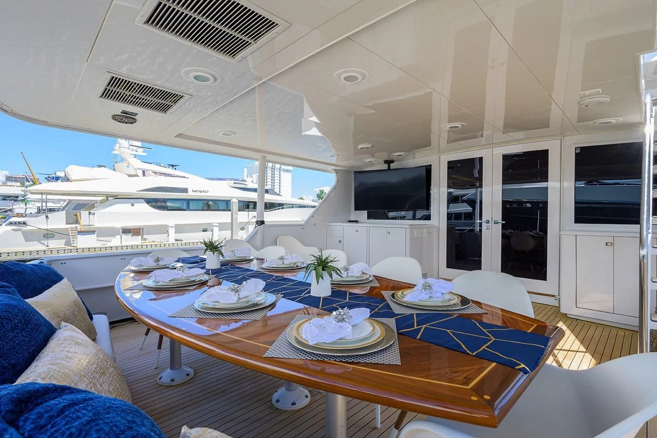 a table with plates and a television on it aboard OCEAN DRIVE Yacht for Sale