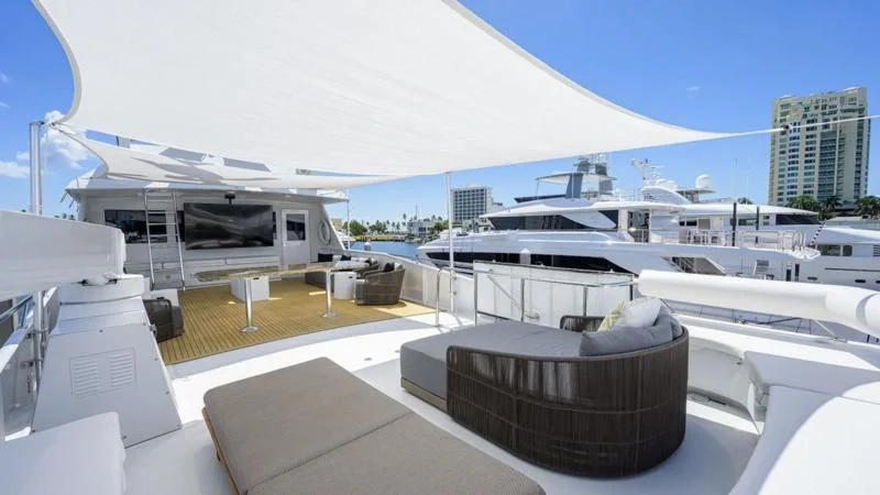 a large white building with a black roof and a large boat in the water aboard OCEAN DRIVE Yacht for Sale