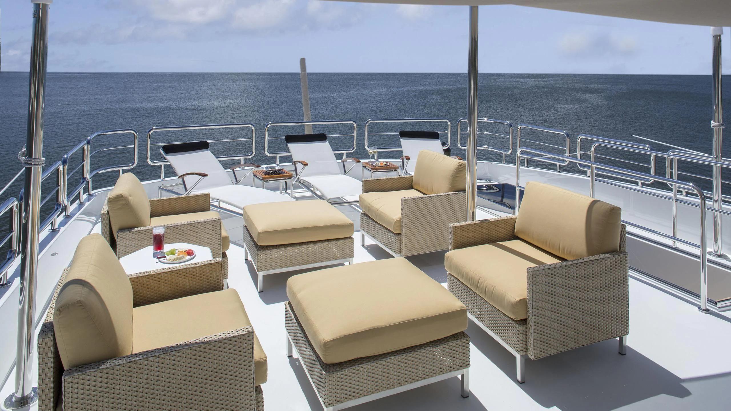 a balcony with chairs and tables aboard TOSCA Yacht for Sale