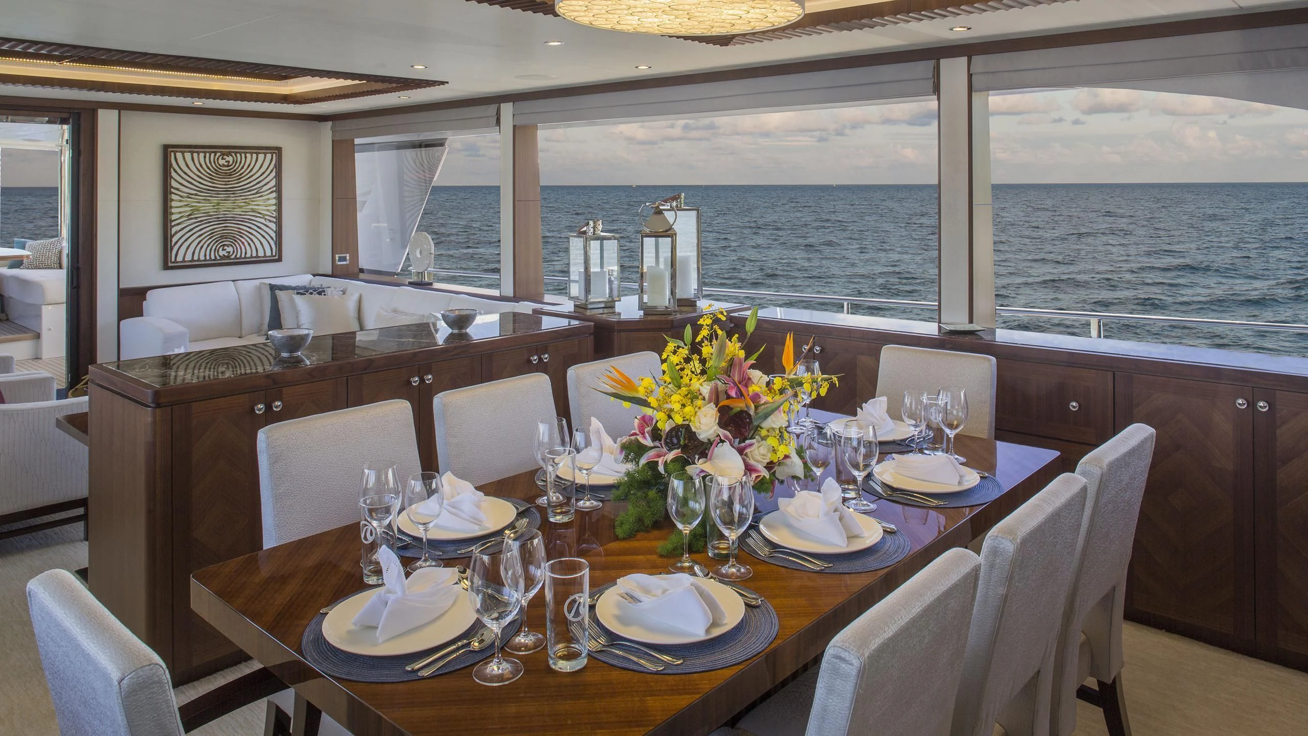 a dining table with a view of the ocean aboard TOSCA Yacht for Sale