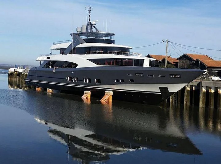 a large boat docked at a pier aboard TOSCA Yacht for Sale