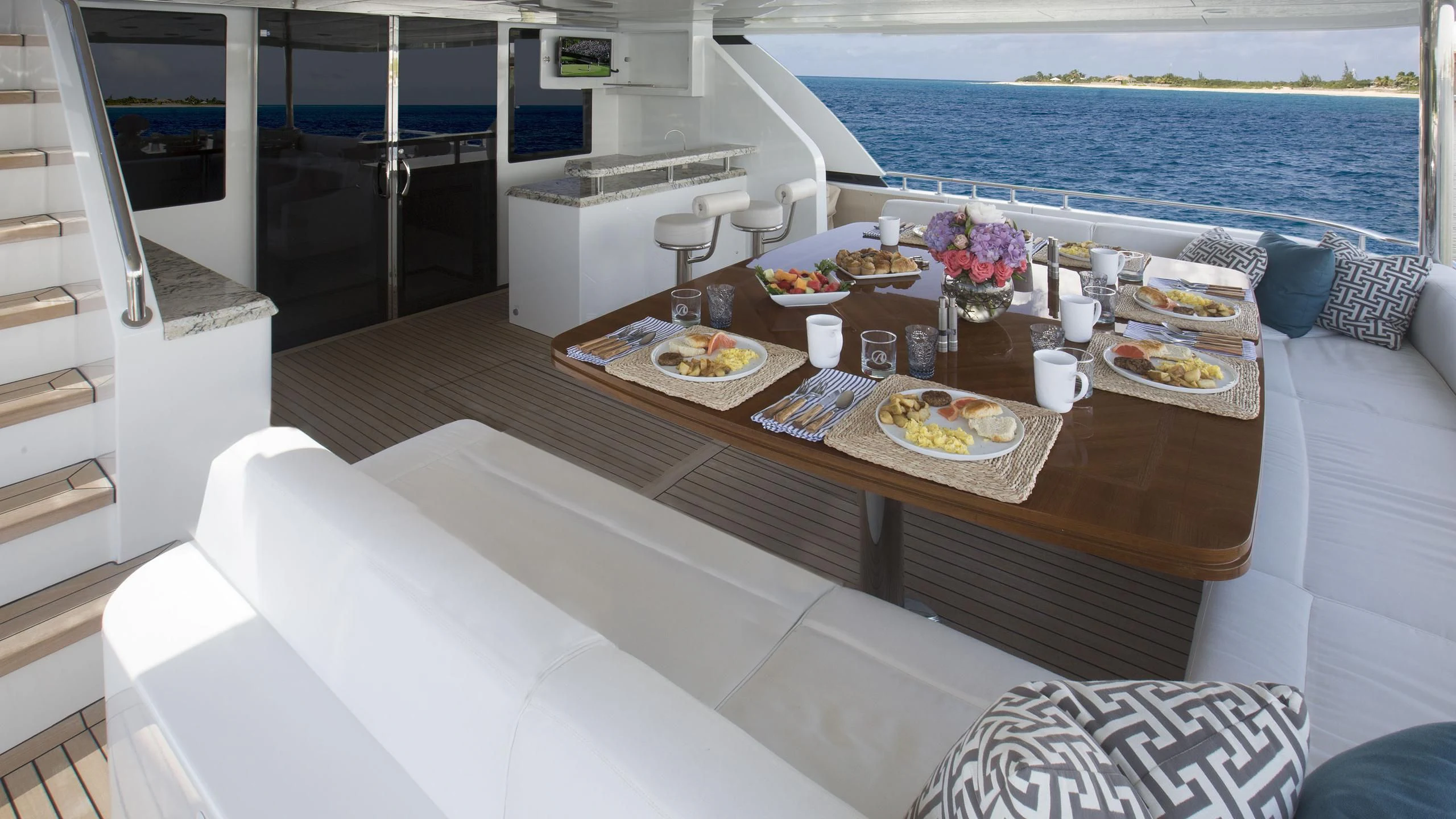 a table with plates and food on it aboard TOSCA Yacht for Sale