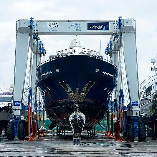 a large white boat with a large black wheel aboard WOLFOZ Yacht for Sale