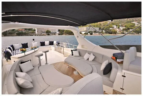 a large white lounge chair on a deck overlooking a large body of water aboard LADY CAROLA Yacht for Sale