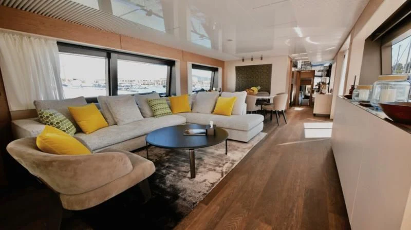 a living room with a large window aboard NINETEEN Yacht for Sale