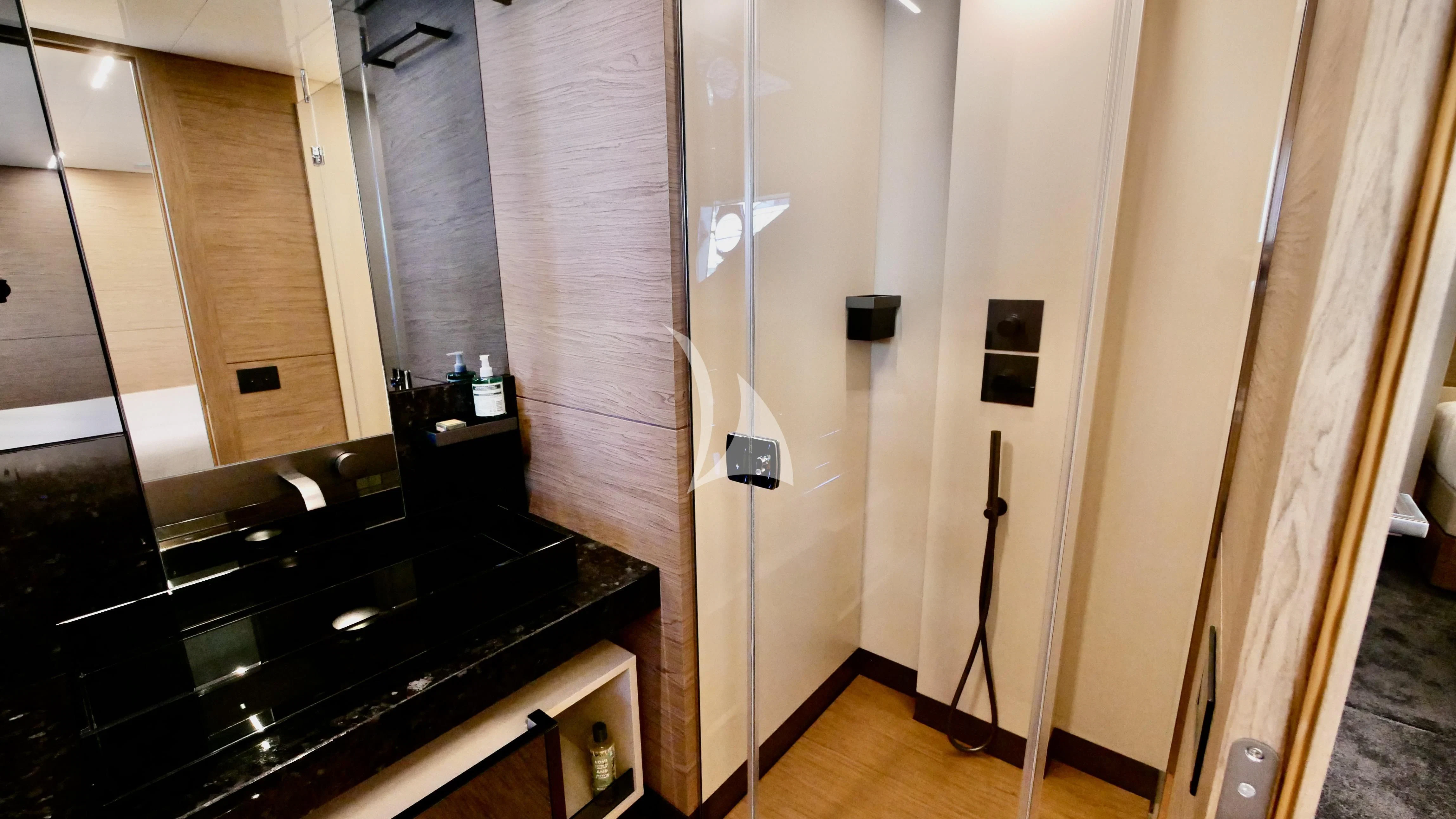 a bathroom with a black countertop aboard NINETEEN Yacht for Sale