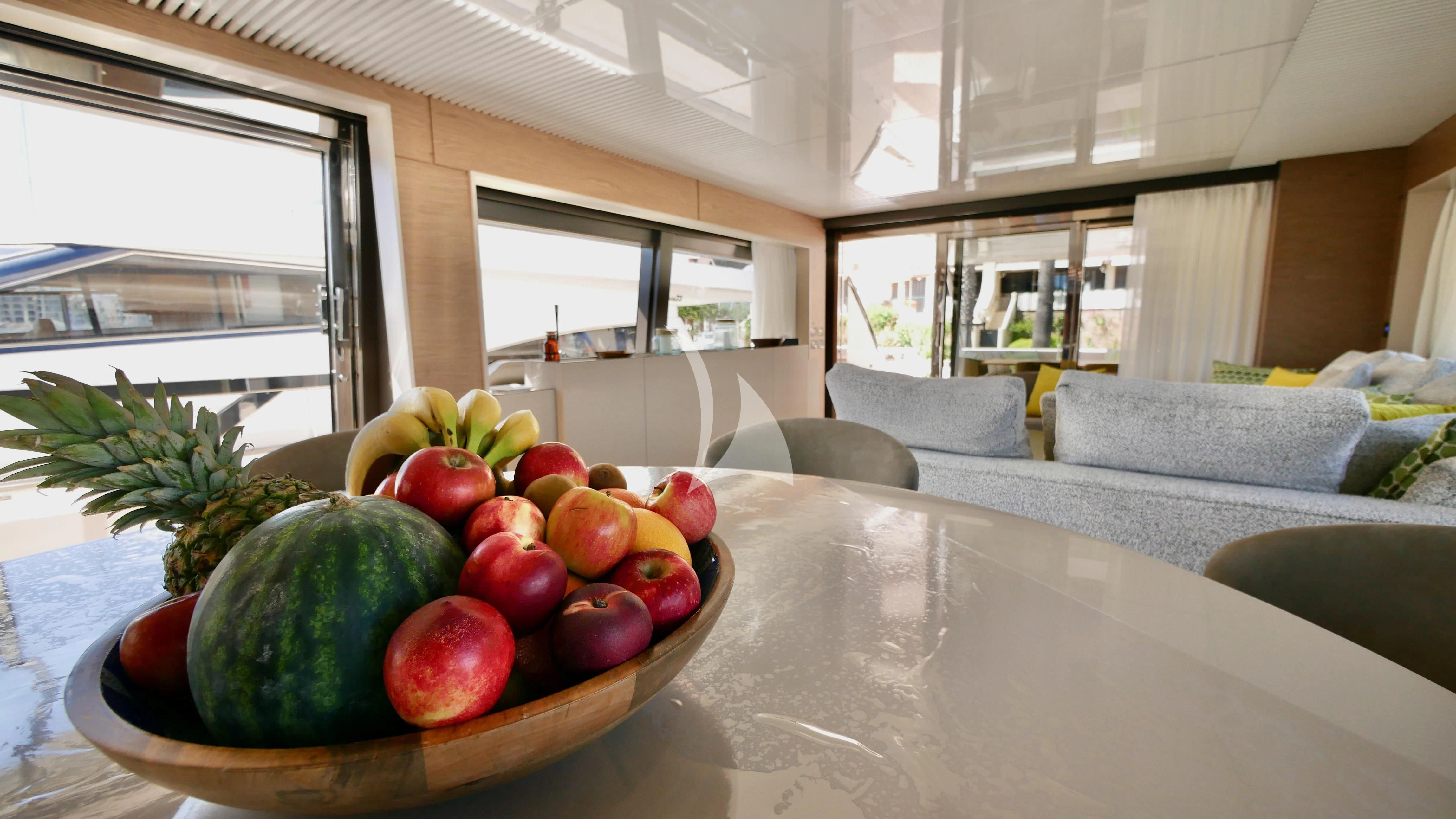 a bowl of fruit on a table aboard NINETEEN Yacht for Sale