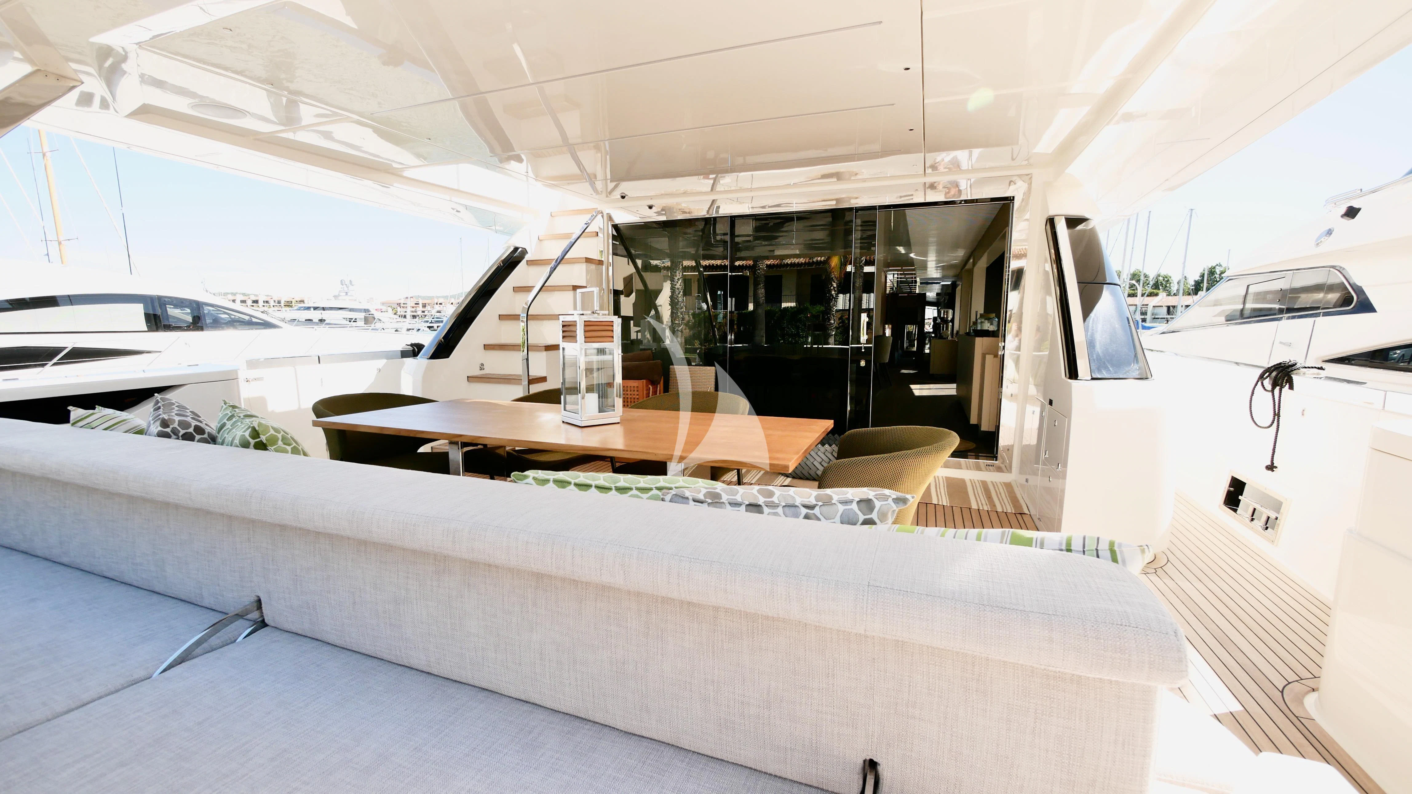 a room with a couch and a table aboard NINETEEN Yacht for Sale